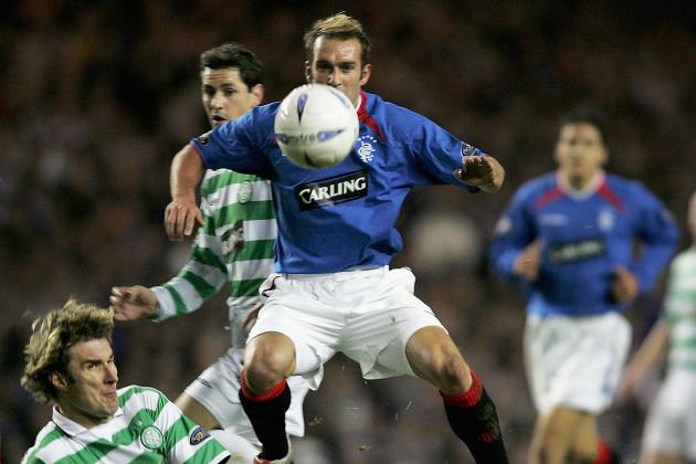 GLASGOW, SCOTLAND - NOVEMBER 10: Fernando Ricksen of Rangers leaps over Stan Varga of Celtic during the CIS Insurance Cup fourth round between Celtic and Rangers at Ibrox on November 10, 2004 in Glasgow, Scotland.  (Photo by Mark Thompson/Getty Images)