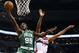 Boston Celtics forward Jae Crowder (99) shoots the ball in front of Washington Wizards guard Garrett Temple (17) in the second half of an NBA basketball game, Saturday, Dec. 27, 2014, in Washington. The Wizards won 101-88. (AP Photo/Alex Brandon)