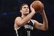 Brooklyn Nets center Brook Lopez (11) takes aim for a could shot during an NBA basketball game against the New York Knicks on Friday, Nov. 7, 2014 at Barclays Center in New York. (AP Photo/Kathy Kmonicek)
