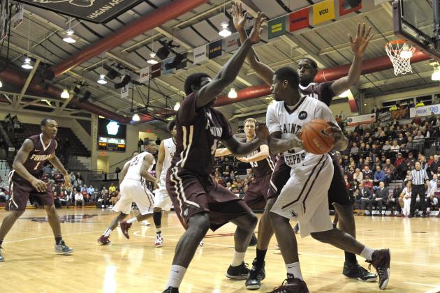 Jan 14, 2015; Philadelphia, PA, USA; Saint Joseph's Hawks guard Aaron Brown (2) is trapped by Fordham Rams guard Eric Paschall (4) and forward Ryan Rhoomes (30) during the second half at Hagan Arena. The Hawks defeated the Rams, 66-55. Mandatory Credit: Eric Hartline-USA TODAY Sports