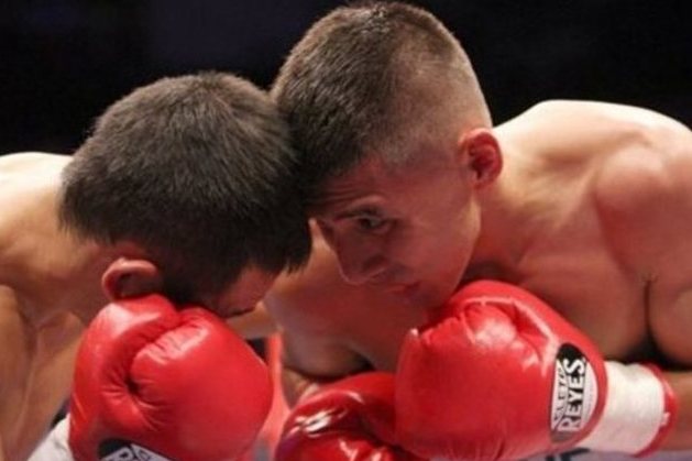 Japan's Katsunari Takayama, left, exchanges a punch with Mexico's Francisco Rodriguez, during their IBF and WBO minimumweight title unification in Monterrey, Mexico, Saturday Aug. 9, 2014. (AP Photo/Alfredo Lopez)