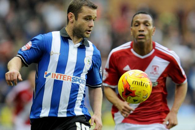 WIGAN, ENGLAND - NOVEMBER 22:  Wigan Athletics Shaun Maloney  (l) vies with Middlesbroughs Emilio Nsue during the Sky Bet Championship match between Wigan Athletic and Middlesbrough at DW Stadium on November 22, 2014 in Wigan, England.  (Photo by Ryan Browne/Getty Images)