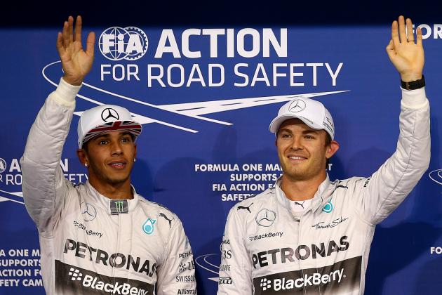 ABU DHABI, UNITED ARAB EMIRATES - NOVEMBER 22:  Nico Rosberg of Germany and Mercedes GP waves to the crowd next to Lewis Hamilton of Great Britain and Mercedes GP after claiming pole position during qualifying for the Abu Dhabi Formula One Grand Prix at Yas Marina Circuit on November 22, 2014 in Abu Dhabi, United Arab Emirates.  (Photo by Mark Thompson/Getty Images)
