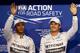 ABU DHABI, UNITED ARAB EMIRATES - NOVEMBER 22: Nico Rosberg of Germany and Mercedes GP waves to the crowd next to Lewis Hamilton of Great Britain and Mercedes GP after claiming pole position during qualifying for the Abu Dhabi Formula One Grand Prix at Yas Marina Circuit on November 22, 2014 in Abu Dhabi, United Arab Emirates. (Photo by Mark Thompson/Getty Images)
