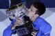 Novak Djokovic of Serbia kisses the trophy after defeating Andy Murray of Britain in the men's singles final at the Australian Open tennis championship in Melbourne, Australia, Sunday, Feb. 1, 2015. (AP Photo/Lee Jin-man)