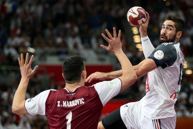 France's Nikola Karabatic, right, attempts a shot on goal past Qatar's Zarko Markovic during the 24th Men's Handball World Championships final match between France and Qatar at the Lusail Multipurpose Hall, in Doha, Qatar, Sunday, Feb. 1, 2015. (AP Photo/Osama Faisal)