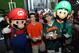 IMAGE DISTRIBUTED FOR NINTENDO - Mario and Luigi cheer on a heated Super Smash Bros. for Wii U battle outside the University of Miami vs. Florida State University football game on Nov. 15, 2014. The Super Smash Bros. for Wii U game, launching on Nov. 21, 2014, is the first fighting game in the series to allow eight local players to play simultaneously.(Photo By Jeff Daly/Invision for Nintendo/AP)