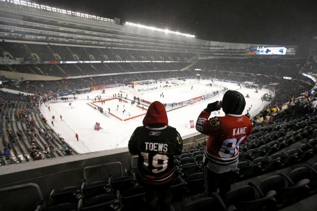Two Chicago Blackhawks fans look out over the ice before an NHL Stadium Series hockey game between the Blackhawks and the Pittsburgh Penguins at Soldier Field on Saturday, March 1, 2014, in Chicago. (AP Photo/Charles Rex Arbogast)