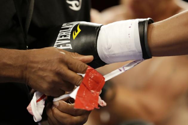 Dennis Galarza has his gloves untaped after he knocked out Cody Walker during a fight, Thursday, July 10, 2014 in Miami. Galarza knocked out Walker at 58 seconds of the first round. (AP Photo/Wilfredo Lee)