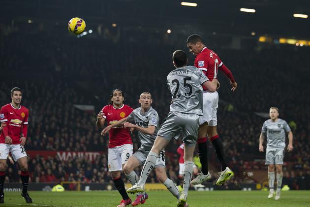 Manchester United's Chris Smalling, upper right, scores his second goal against Burnley during the English Premier League soccer match between Manchester United and Burnley at Old Trafford Stadium, Manchester, England, Wednesday Feb. 11, 2015. (AP Photo/Jon Super)
