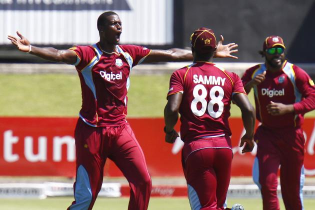 West Indies' Jason Holder, left, celebrates a South Africa wicket during their one day international cricket match in Port Elizabeth, South Africa, Sunday, Jan. 25, 2015. (AP Photo/Michael Sheehan)