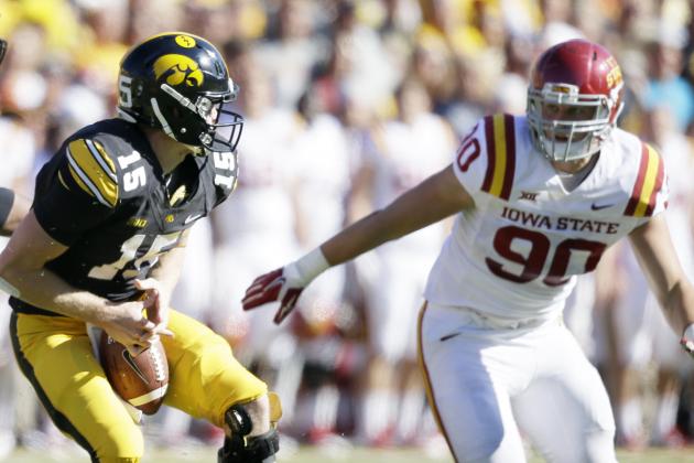 Iowa quarterback Jake Rudock, left, fumbles the ball in front of Iowa State defensive end Mitchell Meyers, right, during the first half of an NCAA college football game, Saturday, Sept. 13, 2014, in Iowa City, Iowa. Iowa State won 20-17. (AP Photo/Charlie Neibergall)