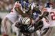 The New York Giants take down New York Jets running back LaDainian Tomlinson (21) during the first quarter of a preseason NFL football game at New Meadowlands Stadium in East Rutherford, N.J., Monday, Aug. 16, 2010. (AP Photo/Frank Franklin II)
