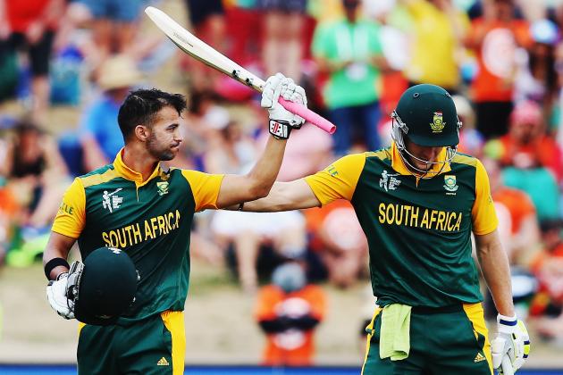 HAMILTON, NEW ZEALAND - FEBRUARY 15:  JP Duminy of South Africa celebrates after scoring a century with David Miller of South Africa during the 2015 ICC Cricket World Cup match between South Africa and Zimbabwe at Seddon Park on February 15, 2015 in Hamilton, New Zealand.  (Photo by Hannah Peters/Getty Images)