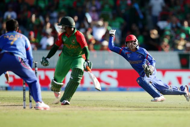 Afghanistan’s wicketkeeper  Zazai Afsar, right, throws the ball at the stumps as he attempts to run out Bangladesh’s Al Hasan Shakib during their Cricket World Cup Pool A match in Canberra, Australia, Wednesday, Feb. 18, 2015. (AP Photo/Rob Griffith)