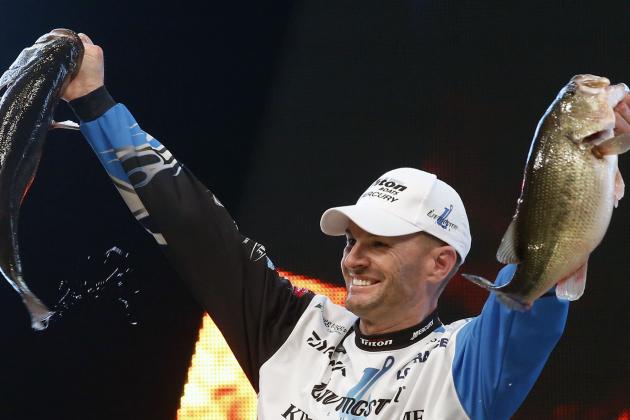 Randy Howell, Springville, Ala., holds up two bass at a weigh-in, Sunday Feb. 23, 2014 in Birmingham, Ala. that helped him win the Bassmaster Classic on Lake Guntersville. (AP Photo/Hal Yeager)