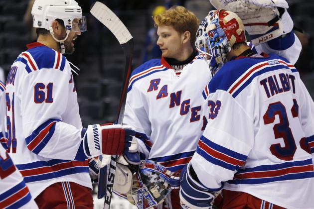 New York Rangers left wing Rick Nash, left, joins backup goalie Mackenzie Skapski, center, in congratulating starting goalie Cam Talbot after the Rangers' 6-3 victory over the Colorado Avalanche in an NHL hockey game Thursday, Feb. 12, 2015, in Denver. (AP Photo/David Zalubowski)