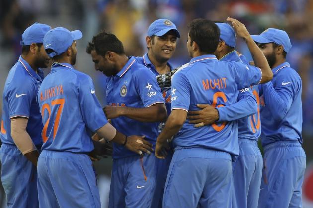 India's Mahendra Singh Dhoni, center, celebrates with teammates a South Africa wicket during their Cricket World Cup pool B match in Melbourne, Australia, Sunday, Feb. 22, 2015. (AP Photo/Rick Rycroft)