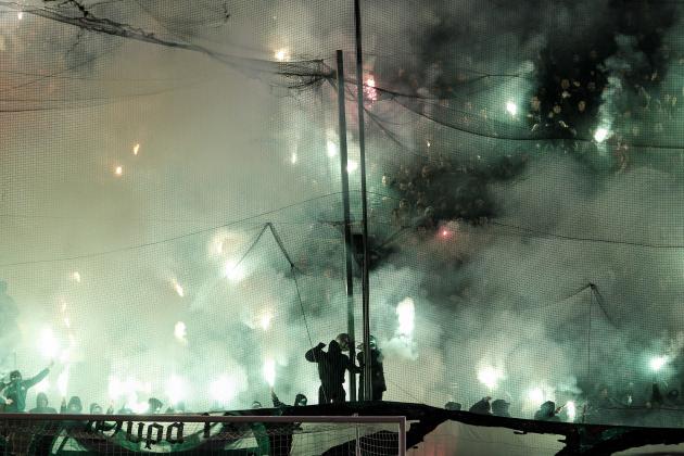Panathinaikos' fans hold flares during a Greek Super League soccer match against Olympiakos at the Apostolos Nikolaides stadium in Athens, Sunday, Feb.22, 2015. (AP Photo/Yorgos Karahalis)