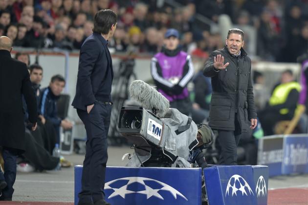 Leverkusen's head coach Roger Schmidt, left, argues with Atletico's coach Diego Simeone during the Champions League round of 16 first leg soccer match between Bayer 04 Leverkusen and Atletico de Madrid on Wednesday, Feb. 25, 2015 in Leverkusen, Germany. (AP Photo/Martin Meissner)