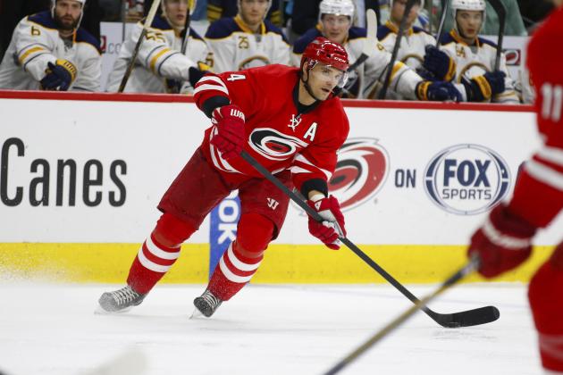 Jan 8, 2015; Raleigh, NC, USA; Carolina Hurricanes defensemen Andrej Sekera (4) skates with puck against the Buffalo Sabres at PNC Arena. The Hurricanes defeated the Sabres 5-2. Mandatory Credit: James Guillory-USA TODAY Sports