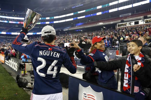 New England Revolution's Lee Nguyen holds the MLS Eastern Conference Champion's Cup as he celebrates with fans at Gillette Stadium after the second soccer game against the New York Red Bulls of the MLS Eastern Conference final in Foxborough, Mass., Saturday, Nov. 29, 2014. The match ended 2-2 and New England advanced with a two-game aggregate 4-3. (AP Photo/Elise Amendola)