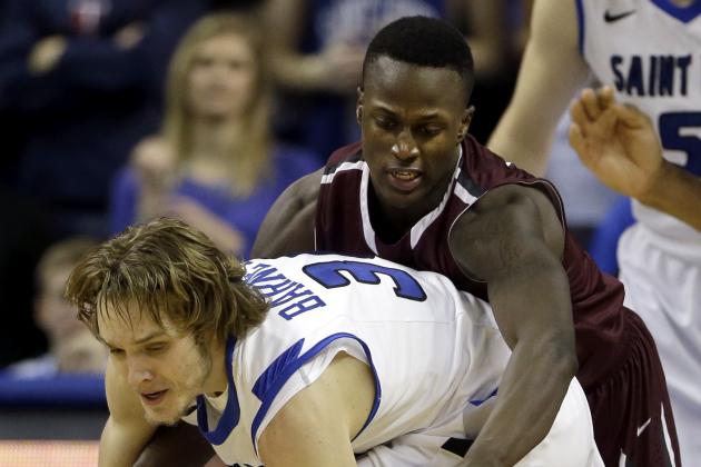 Saint Louis' Jake Barnett, front, and Fordham's Bryan Smith reach for a loose ball during the second half of an NCAA college basketball game Saturday, Jan. 18, 2014, in St. Louis. Saint Louis won 70-48. (AP Photo/Jeff Roberson)