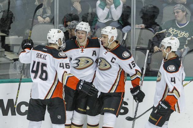 Anaheim Ducks players Jiri Sekac (46), Ryan Getzlaf (15) and Cam Fowler (4) congratulalte right wing Corey Perry, 2nd from left, for his goal against Dallas Stars goalie Jhonas Enroth in the first period of an NHL hockey game Sunday, March 1, 2015, in Dallas.  (AP Photo/Tim Sharp)