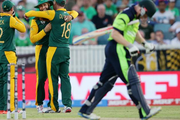 South Africa's Hashim Amla, centre, is congratulated by teammates Quinton De Kock and Francois Du Plessis, right, after taking a catch to dismiss Ireland's Niall O'Brien, right, during their Cricket World Cup Pool B match in Canberra, Australia, Tuesday, March 3, 2015. (AP Photo/Rob Griffith)