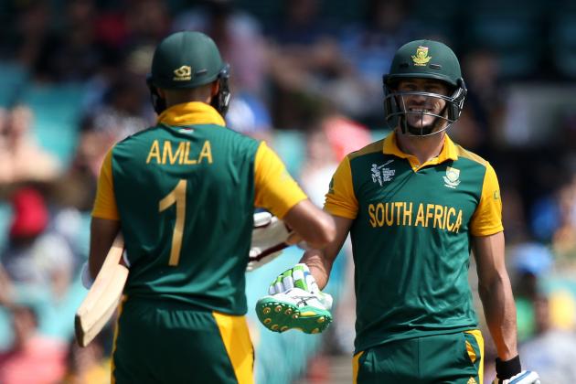 South Africa's Francois Du Plessis, right, hands teammate Hashim Amla is shoe that came off while batting during their Cricket World Cup Pool B match against the West Indies in Sydney, Australia, Friday, Feb. 27, 2015. (AP Photo/Rick Rycroft)