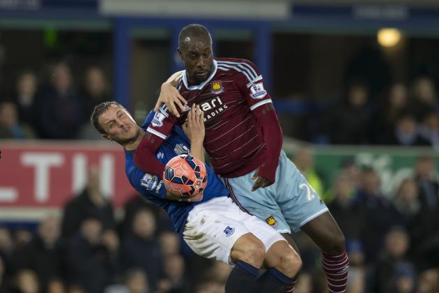 Everton's Philip Jagielka, left, fights for the ball against West Ham United's Carlton Cole during their English FA Cup third round soccer match at Goodison Park Stadium, Liverpool, England, Tuesday Jan. 6, 2015. (AP Photo/Jon Super)