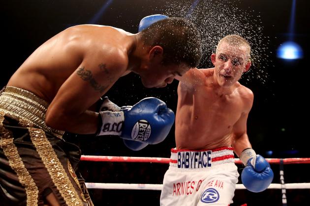 LIVERPOOL, ENGLAND - DECEMBER 07: Paul Butler (R) catches Ruben Montoya during their WBO and Vacant WBA Intercontinental Super Flyweight Championship bout at Liverpool Echo Arena on December 7, 2013 in Liverpool, England. (Photo by Scott Heavey/Getty Images)
