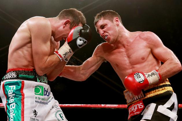 HULL, ENGLAND - JULY 13:  Derry Matthews (L) in action with Tommy Coyle during their Vacant Commonwealth Lightweight Championship bout at Craven Park Stadium on July 13, 2013 in Hull, England.  (Photo by Scott Heavey/Getty Images)