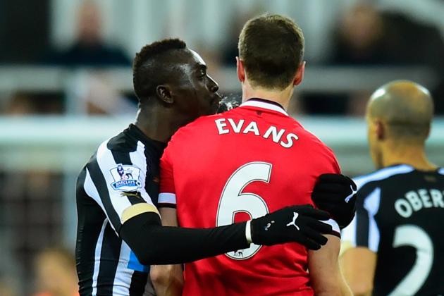 NEWCASTLE UPON TYNE, ENGLAND - MARCH 04:  Manchester United player Jonny Evans (r) looks on as Papiss Cisse of Newcastle appears to spit during the Barclays Premier League match between Newcastle United and Manchester United at St James' Park on March 4, 2015 in Newcastle upon Tyne, England.  (Photo by Stu Forster/Getty Images)