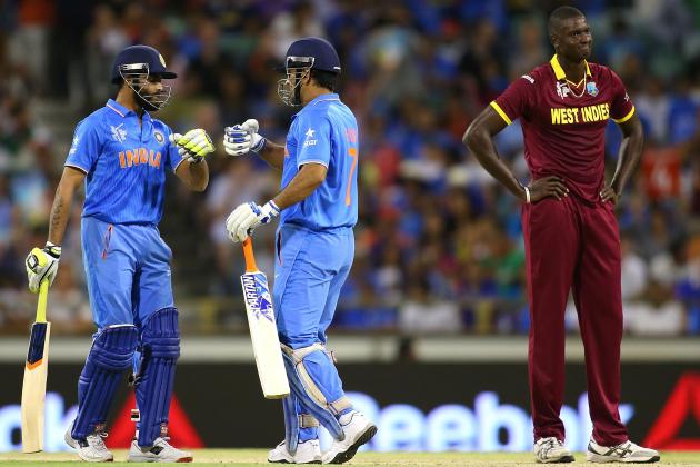 PERTH, AUSTRALIA - MARCH 06: Ravindra Jadeja and MS Dhoni of India celebrate a boundary as Jason Holder of the West Indies looks on during the 2015 ICC Cricket World Cup match between India and the West Indies at WACA on March 6, 2015 in Perth, Australia. (Photo by Paul Kane/Getty Images)