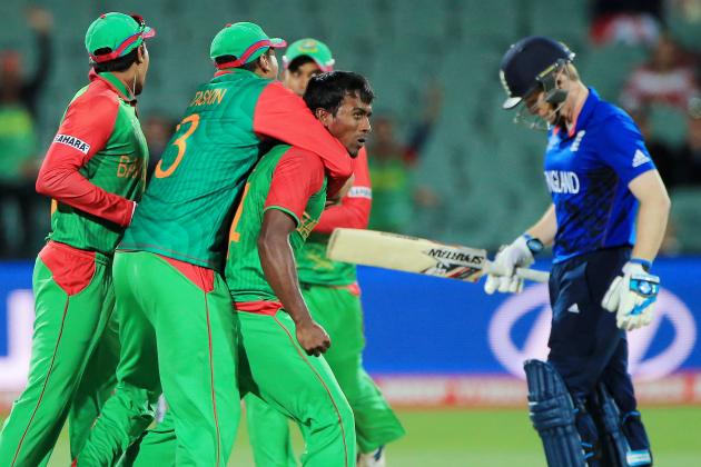 Bangladesh’s Rubel Hossain is embraced by teammates after dismissing England’s captain Eoin Morgan, right, during their Cricket World Cup Pool A match in Adelaide, Australia, Monday, March 9, 2015. (AP Photo/James Elsby)