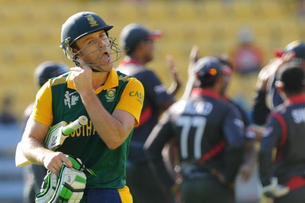 South African batsman A.B de Villiers, left, walks as United Arab Emirates players celebrate after he was out caught for 99 runs during their Cricket World Cup Pool B match in Wellington, New Zealand, Thursday, March 12, 2015. (AP Photo/Ross Setford)