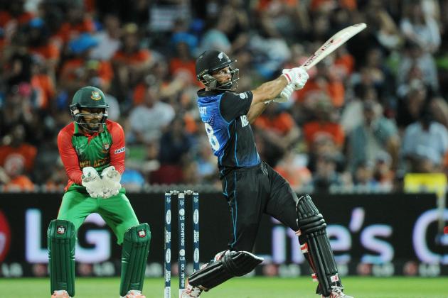 New Zealand’s Martin Guptill hits the ball as Bangladesh wicketkeeper Mushfiqur Rahim  watches during their Cricket World Cup Pool A match in Hamilton, New Zealand, Friday, March 13, 2015. (AP Photo/Ross Setford)