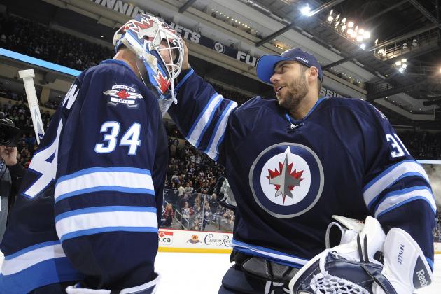 WINNIPEG, CANADA - MARCH 1: Goaltender Michael Hutchinson #34 of the Winnipeg Jets gets congratulated by teammate Ondrej Pavelec #31 after backstopping the Jets to a 5-2 victory over the Los Angeles Kings on March 1, 2015 at the MTS Centre in Winnipeg, Manitoba, Canada. (Photo by Lance Thomson/NHLI via Getty Images)