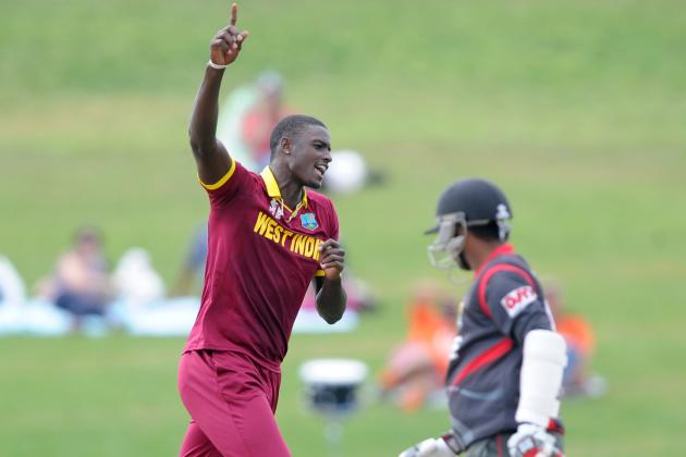 West Indies bowler Jason Holder celebrates after bowling United Arab Emirates batsman Swapnil Patil, right, during their Cricket World Cup Pool B match in Napier, New Zealand, Sunday, March 15, 2015. (AP Photo/Ross Setford)
