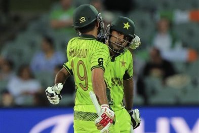 Pakistan’s Sarfraz Ahmed, right is congratulated by teammate Ahmed Shahzad, for his fifty runs during their Cricket World Cup Pool B match against Ireland in Adelaide, Australia, Sunday, March 15, 2015. (AP Photo/James Elsby)