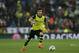 Dortmund's Nuri Sahin runs with the ball during a Champions League quarterfinal first leg soccer match between Real Madrid and Borussia Dortmund at the Santiago Bernabeu stadium in Madrid, Spain, Wednesday April 2, 2014. (AP Photo/Paul White)