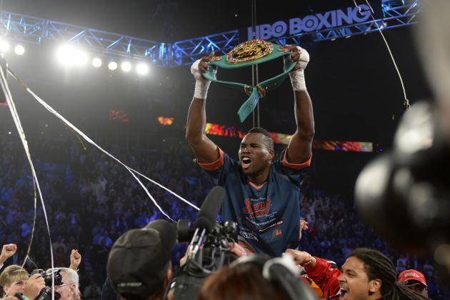 Jun 8, 2013; Montreal, Quebec, Canada; Adonis Stevenson (gold/yellow) celebrates with the belt after knocking out Chad Dawson (not pictured) during the first round of their light heavyweight  WBC title bout at the Bell Centre. Mandatory Credit: Eric Bolte-USA TODAY Sports