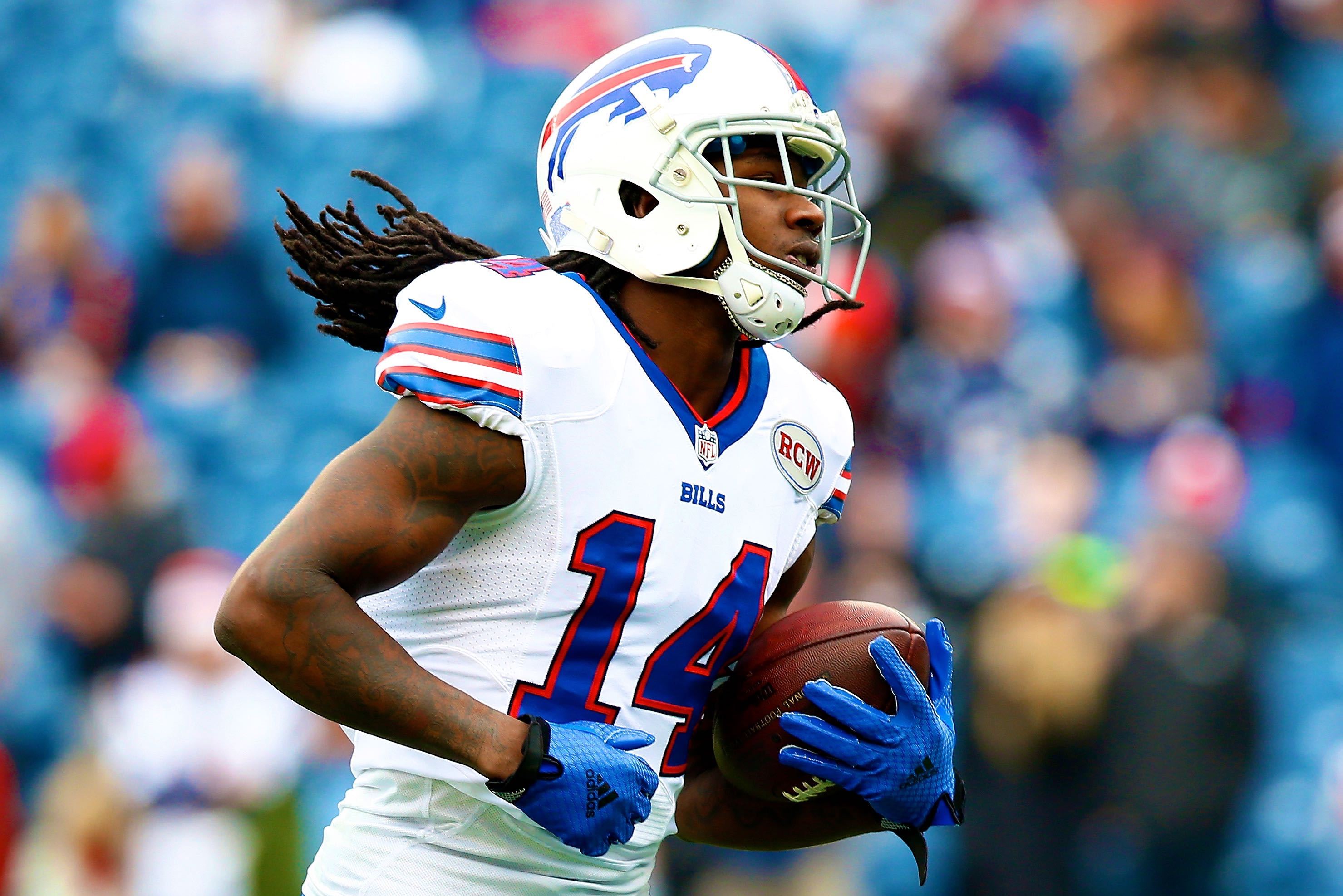 Buffalo Bills' Jerry Hughes gets his helmet stuck on teammate's jersey