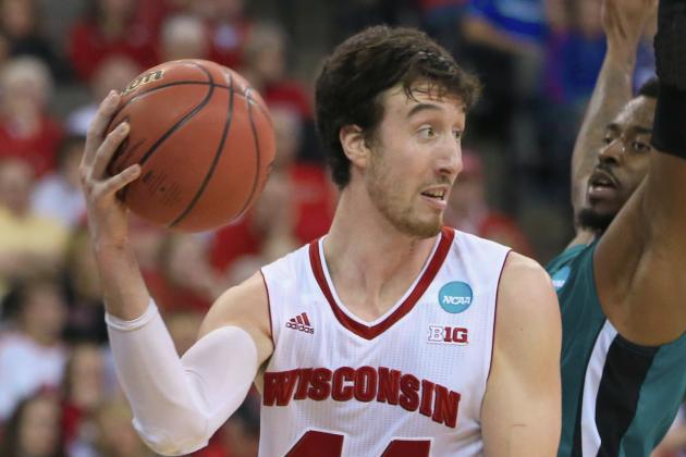 Wisconsin's Frank Kaminsky (44) passes the ball around Coastal Carolina's Josh Cameron (3) during the second half of an NCAA tournament college basketball game in the Round of 64 in Omaha, Neb., Friday, March 20, 2015. (AP Photo/Nati Harnik)