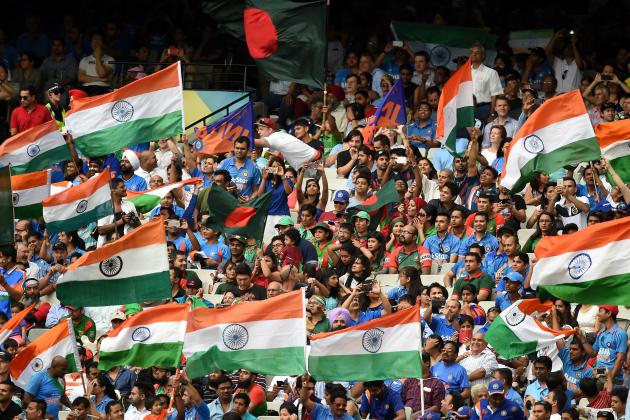 Indian fans wave their flags as they cheer their team during their Cricket World Cup quarterfinal match against Bangladesh in Melbourne, Australia, Thursday, March 19, 2015. (AP Photo/Andy Brownbill)