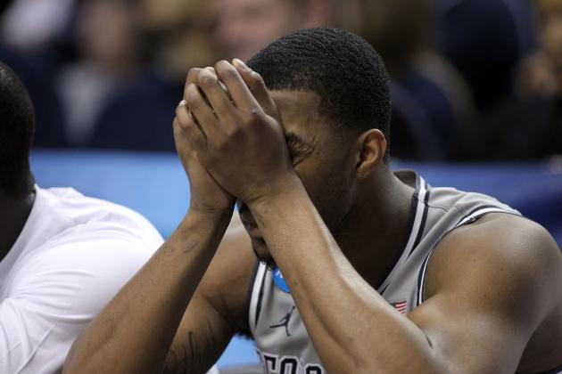 Georgetown forward Mikael Hopkins sits on the bench with head in hands during the final moments of an NCAA college basketball tournament round of 32 game against Utah in Portland, Ore., Saturday, March 21, 2015.  Utah beat Georgetown 75-64. (AP Photo/Craig Mitchelldyer)