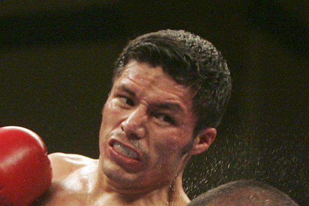 Jhonny Gonzalez, left, lands a punch to the face of Tomas Villa, of Mexico. Gonzalez's won by a TKO at 49 seconds in the fourth round as Gonzalez retained the WBC World Featherweight title in Atlantic City N.J. Saturday, July 9, 2011. (AP Photo/Rich Schultz)