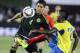 Mexico's defender Hugo Ayala left, and Ecuador's forward Miler Boanos battle for a ball during the first half of an international friendly soccer game Saturday, March 28, 2015, in Los Angeles, Calif. (AP Photo/Ringo H.W. Chiu)