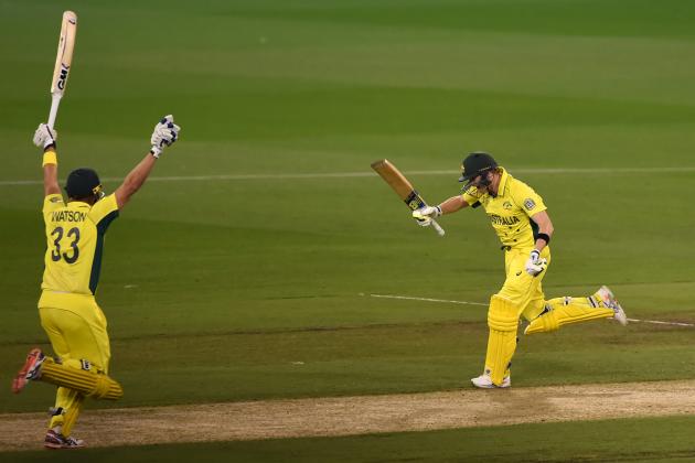 Australia's Steve Smith, right, lunges forward to take the final run along with teammate Shane Watson for their seven wicket win over New Zealand in the Cricket World Cup final in Melbourne, Australia, Sunday, March 29, 2015. (AP Photo/Andy Brownbill)